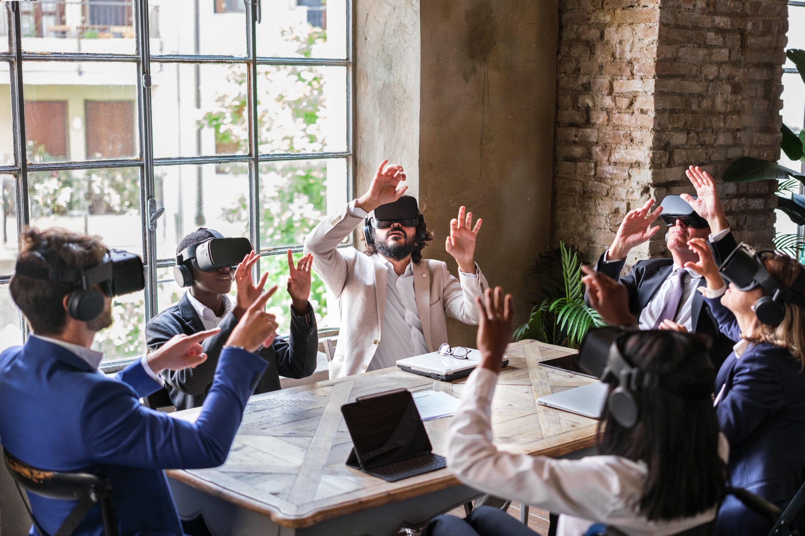 Team of Virtual Assistants - Sat around table wearing virtual masks