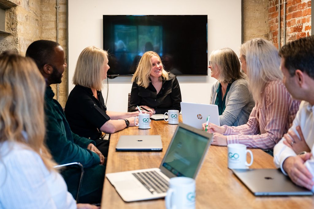 GO Get Organised team sitting around a desk